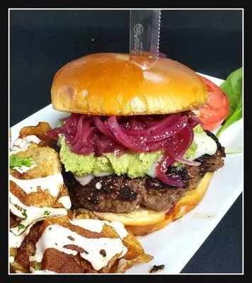 Pesto Burger with candied red onions and house chips