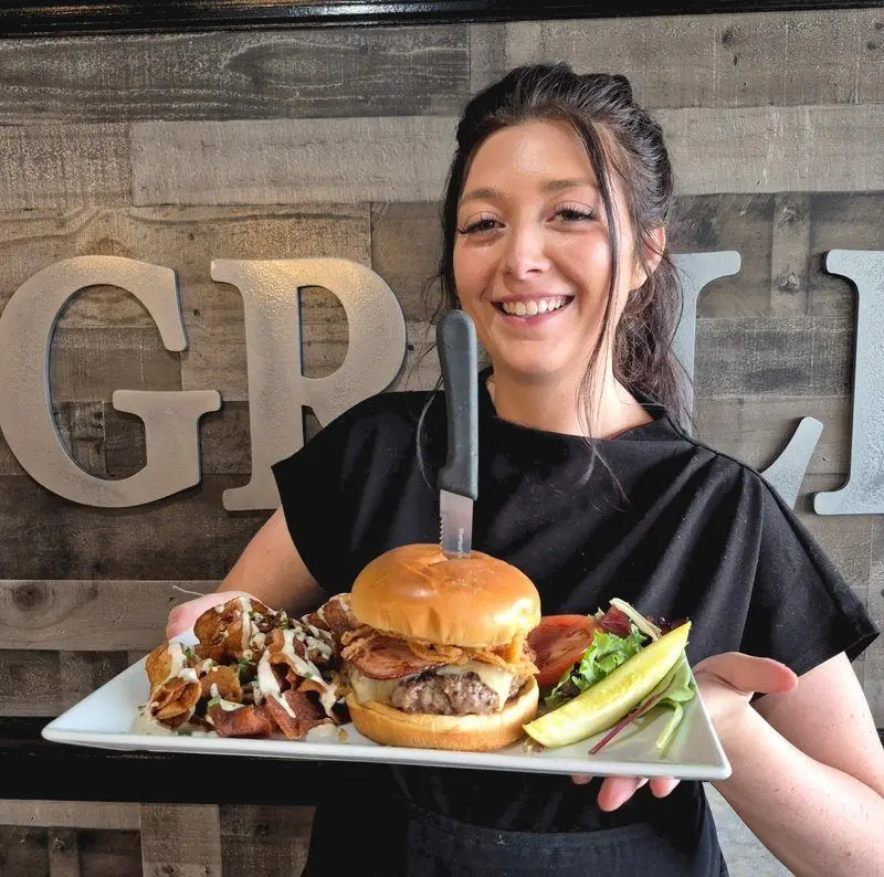 Server with the Grille's signature burger